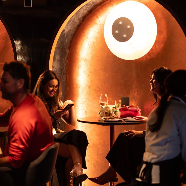 Guests enjoying drinks in a premium hospitality lounge